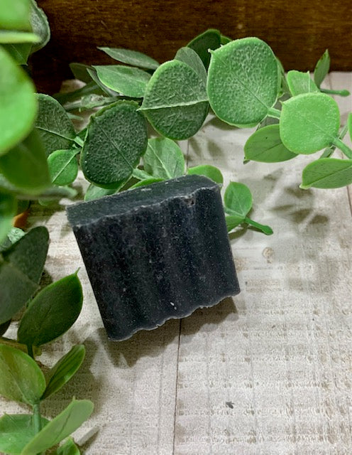 Sample bar of the All Natural Activated Charcoal Tea Tree Soap. Sample bars are hand cut and average 0.5 - 1 oz in weight.    Ingredients: tallow, olive oil, coconut oil, argan oil, lye, tea tree oil, activated charcoal.  Used for psoriasis, eczema, acne