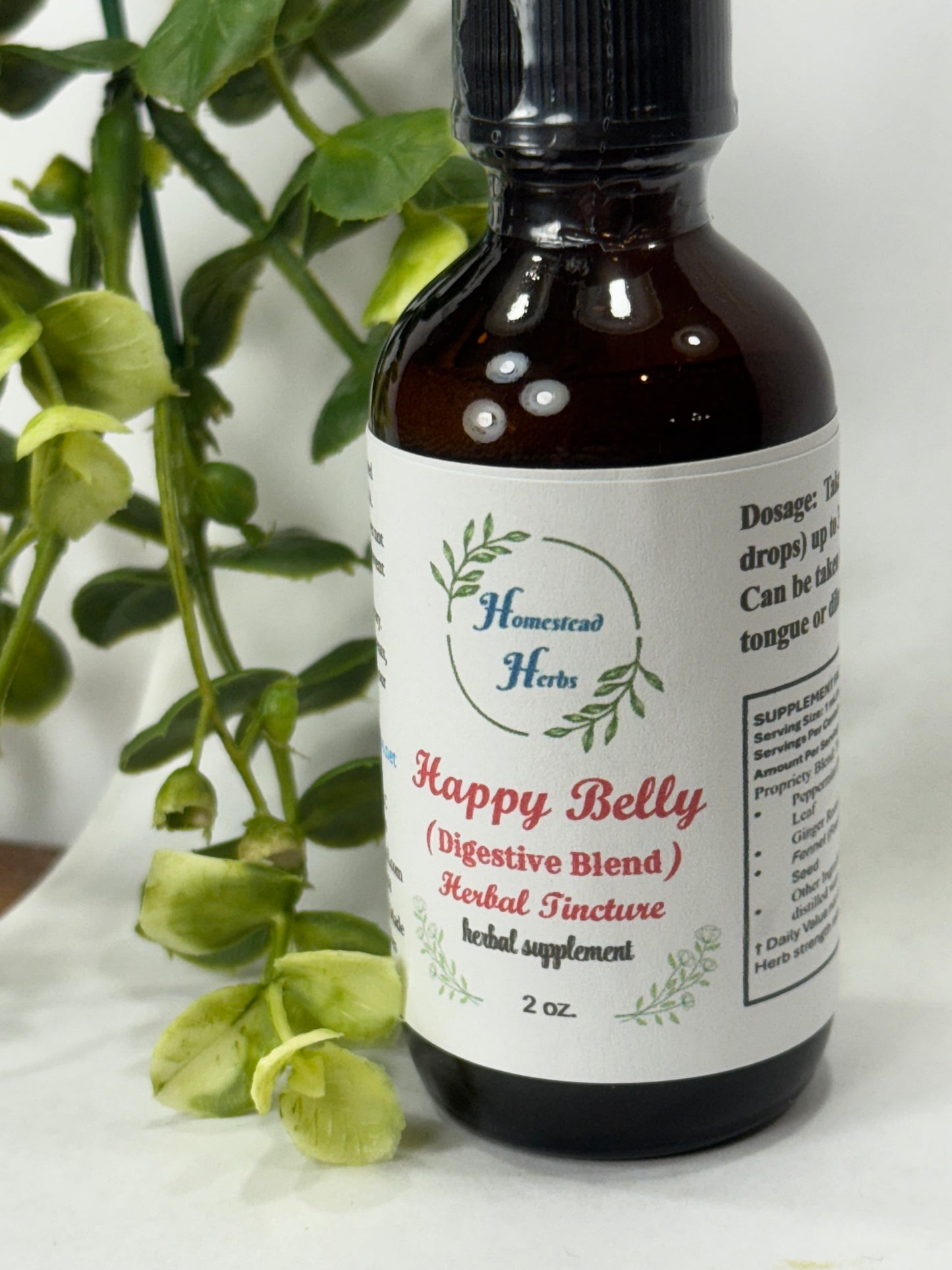 Happy Belly herbal digestive tincture styled in a wellness setting, promoting gut comfort and natural support